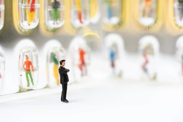 Miniature people, recruiters finding the candidates on the wall.