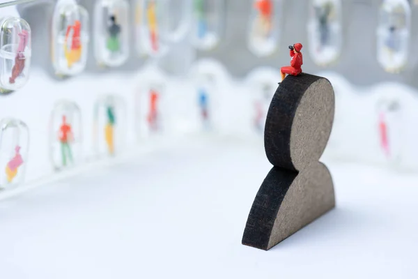 Miniature people, recruiters on wooden people sign for finding t