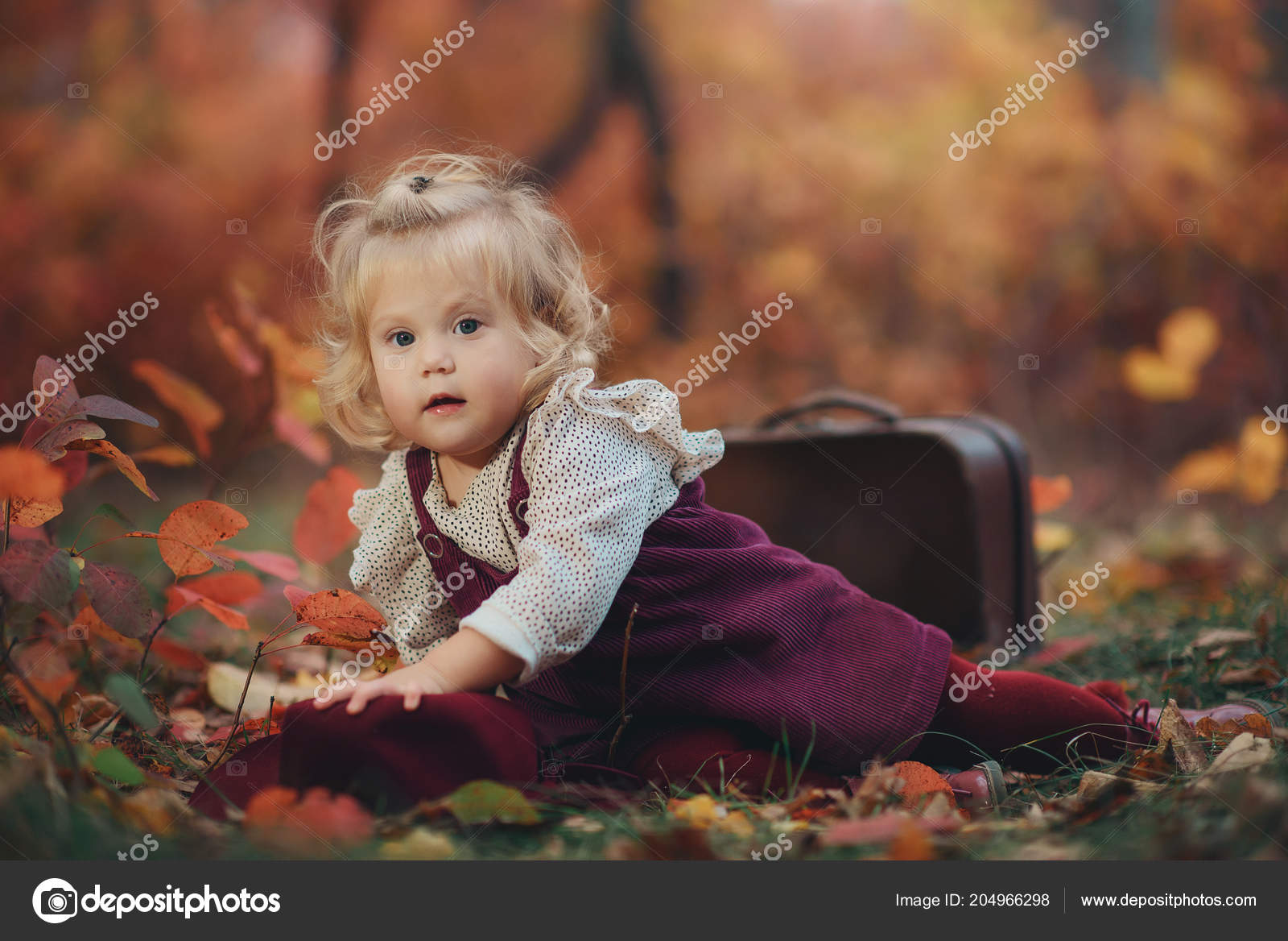 Portrait Of A Cute Little Blonde Girl With Wavy Hair In An