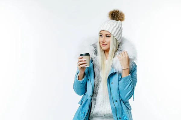 Fashion studio portrait of beautiful lady in blue fur coat and fur hat. Winter beauty in luxury. Fashion fur. Beautiful woman in luxury fur coat. Fashion model posing in eco-fur coat and eco-fur hat