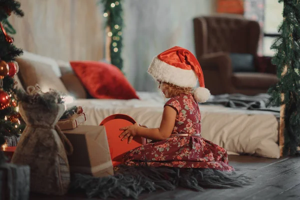 Little Cute Girl Sits Christmas Tree Looking Glowing Christmas Gift — Stock Photo, Image