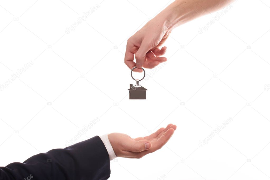 Hand of businessman passing a set of apartment keys to another hand. Clipping path isolated on white. the property