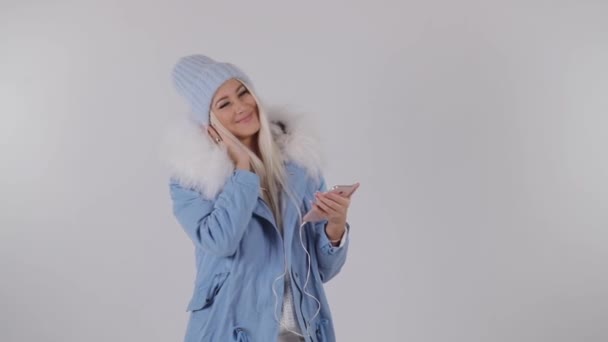 Νεαρό Ξανθιά Ένα Χειμερινό Μπουφάν Είναι Αναμονή Για Μια Κλήση — Αρχείο Βίντεο