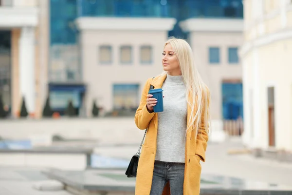 Kaffee Unterwegs Schöne Junge Blonde Frau Leuchtend Gelbem Mantel Kaffeetasse — Stockfoto