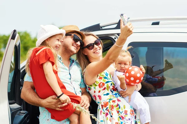 Vacation, Travel - happy family ready for the travel for summer vacation. People have fun and take pictures on the phone. Take a selfie on the memory of the journey