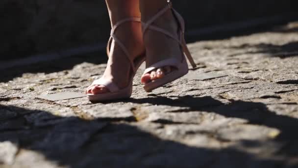 Lady legs with orange pedicure in high heeled shoes — Stock Video