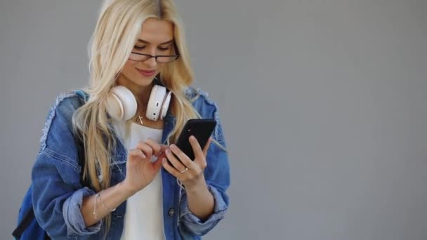 Snygg Student Tjej Jeansjacka Med Smartphone Och Hörlurar City Street — Stockvideo