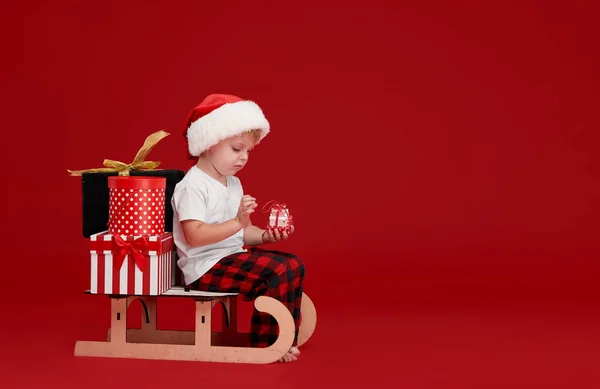 Adorable Little Child Wearing Red Pajamas Santa Claus Hat Sitting — Stock Photo, Image