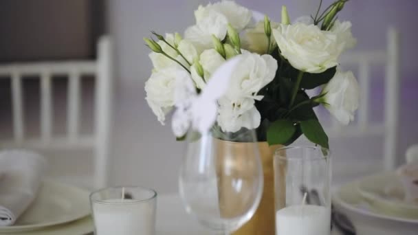 Украшение свадебного стола белыми букетиками цветов — стоковое видео