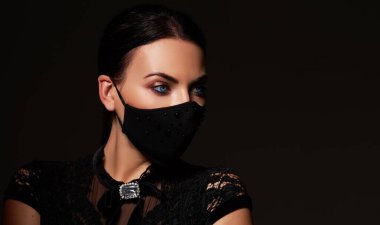 Stylish woman model  wearing designer cloth  face mask protect against coronavirus. Reusable fashionable face mask. 