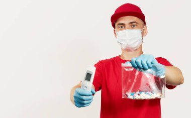 A courier in a red uniform, protective mask and gloves delivers pill drug and thermometer. Stay at home and take care of your health. Courier drug delivery clipart