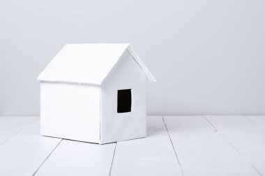 ahşap yüzeyde küçük beyaz kulübe