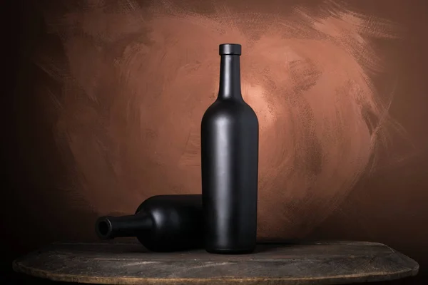 Garrafa de vinho tinto em um fundo marrom de madeira — Fotografia de Stock