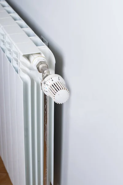 A White heating radiator on the wall. — Stock Photo, Image