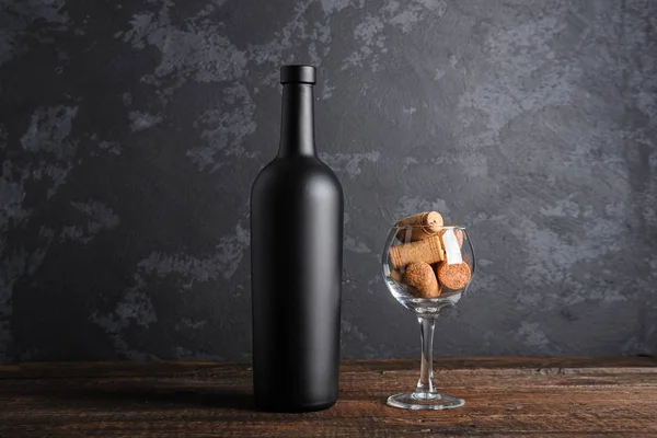 Ahşap arka planda kırmızı şarap şişesi.
