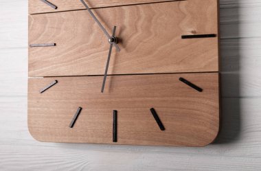 Beautiful Wall Clock Made of Wood on Wood Background clipart
