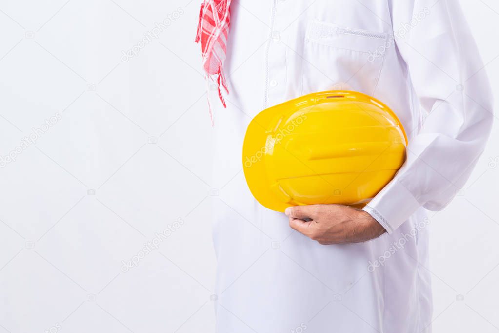 Arab Engineer holding yellow helmet for construction controling with white background and copy space.