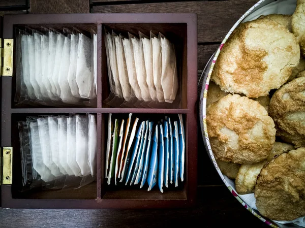 box with tea bags and pastries on another box