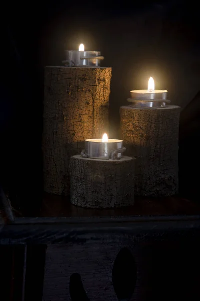 Three Candles Lit Wooden Candlesticks — Stock Photo, Image