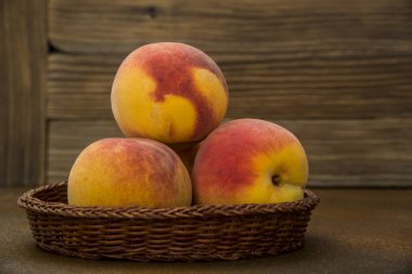 Rustik arka planda hasır sepette şeftali