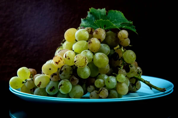 ripe white grapes on a dish