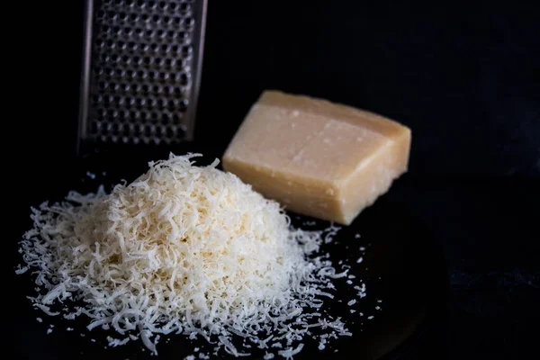 Hand Grated Parmesan Cheese Black Plate Royalty Free Stock Photos