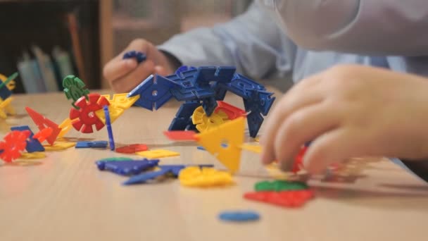 Handen van onbekende jongen spelen met het bouwen van kit — Stockvideo