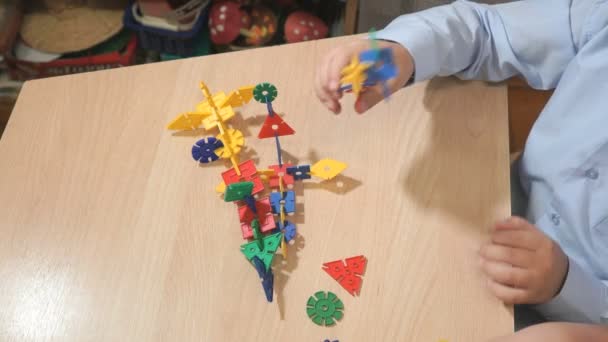 Manos de niño desconocido jugando con el kit de construcción — Vídeos de Stock