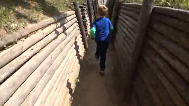 Scared little boy running through the trench — Stock Video