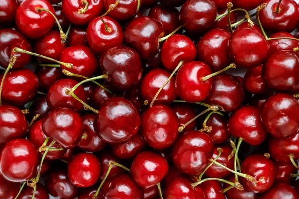 Ripe red sweet cherries top view, background
