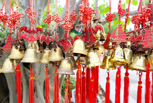 rows of red wind bells golden buddhist prosperity bell at chinese temple people wish and hang them