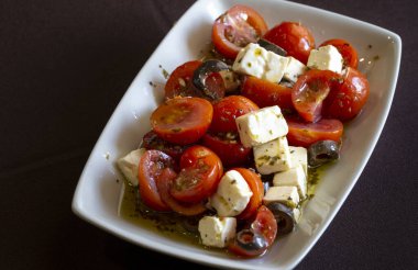 Peynirli, zeytinli ve aromalı domates salatası..