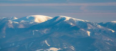 Borisov, Plosna and Cierny kamen hills in winter Velka Fatra mountains in Slovakia clipart
