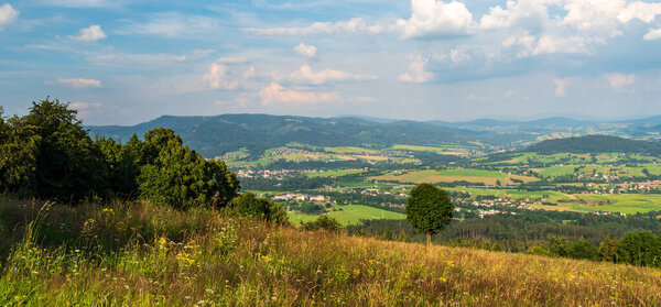 View from Mala Kycera hill in Moravskoslezske Beskydy mountains near Jablunkov town in Czech republic during summer evening