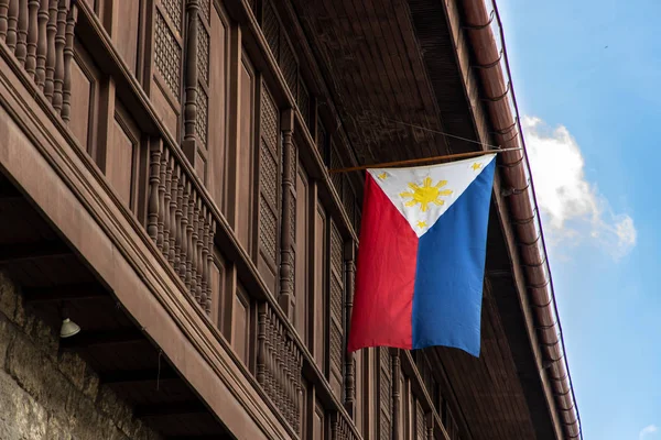 Philippines flag hoisted on house eaves