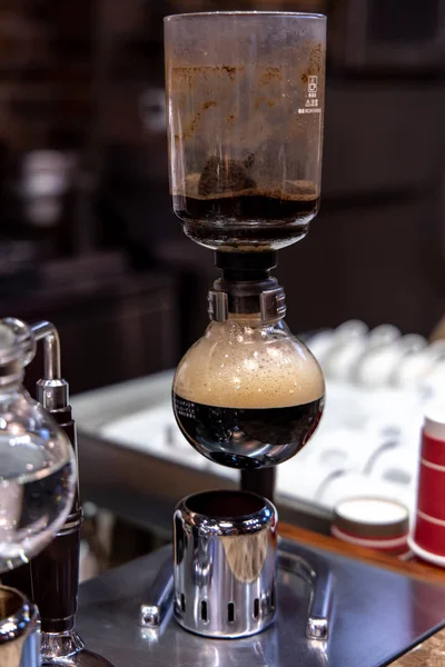 Barista doing Siphon Coffee Brewing