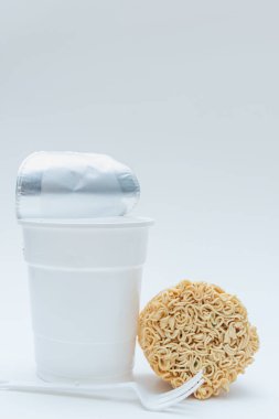 Beyaz arka plan üzerinde kuru anlık erişte ve boş Kupası