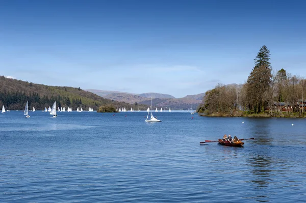 stock image South Lakeland, UK - April 2018: Tourists rowing boat on scenic Lake Windermere in Lake District National Park, North West England, UK