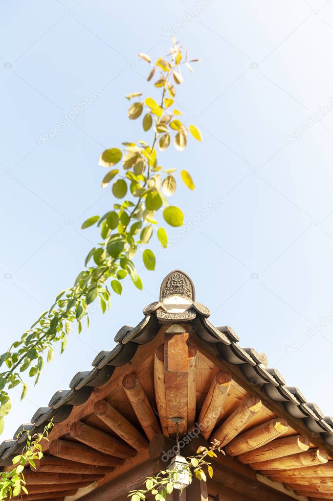 Architectural details of wooden eaves and ceramic tile roof ends of a tradition house at Korean ancient village in Jeonju, South Korea