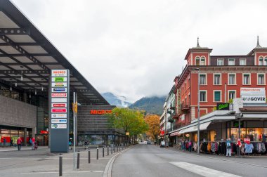 Interlaken, Switzerland - October 2019: Local branch of Migros, a supermarket located on station road in downtown Interlaken, a famous resort town destination in Switzerland clipart