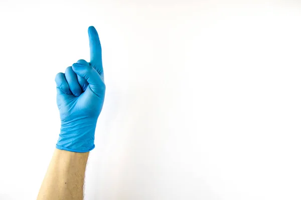 Male hand in medical glove on white background. — Stock Photo, Image