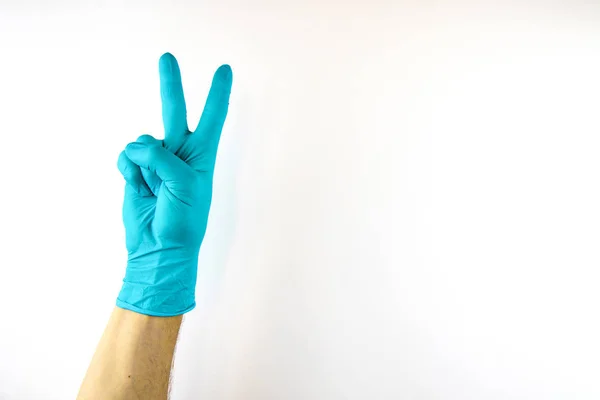 Male hand in medical glove on white background. — Stock Photo, Image