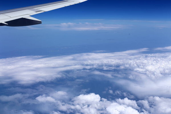 in the porthole can be seen the wing of a jet aircraft 