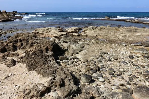 Akdeniz kıyısında açık bir parkta taş yalan 
