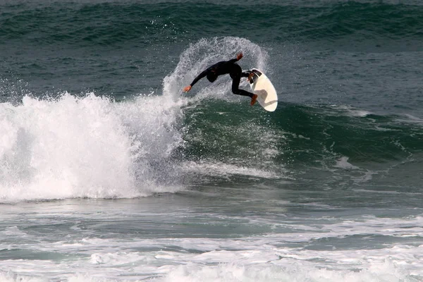 Surfing - riding the waves in the Mediterranean on special light boards.