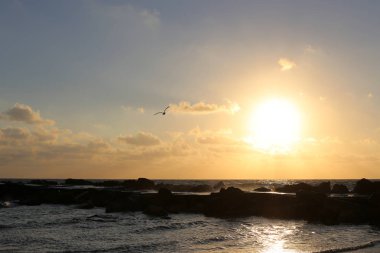 Güneş ufukta ayarlar ve gün Akdeniz'de İsrail tarihinde sona erer 
