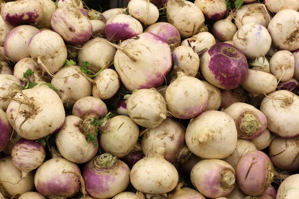 on the counter in the store are fresh vegetables and fruits