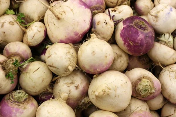 on the counter in the store are fresh vegetables and fruits