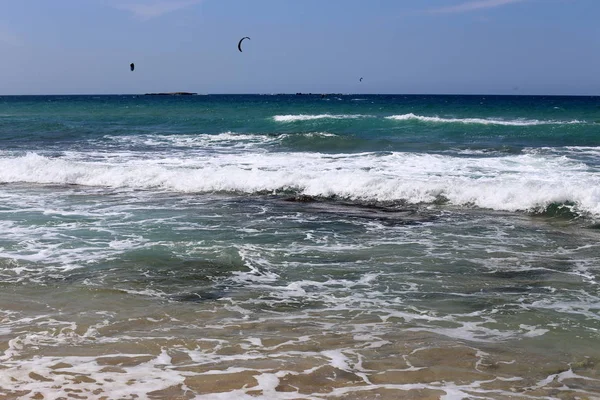 kiteboarding - riding the waves in the Mediterranean on special light boards and wings