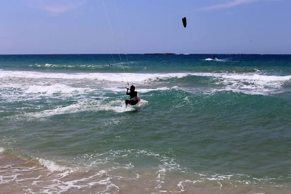 kiteboarding - riding the waves in the Mediterranean on special light boards and wings